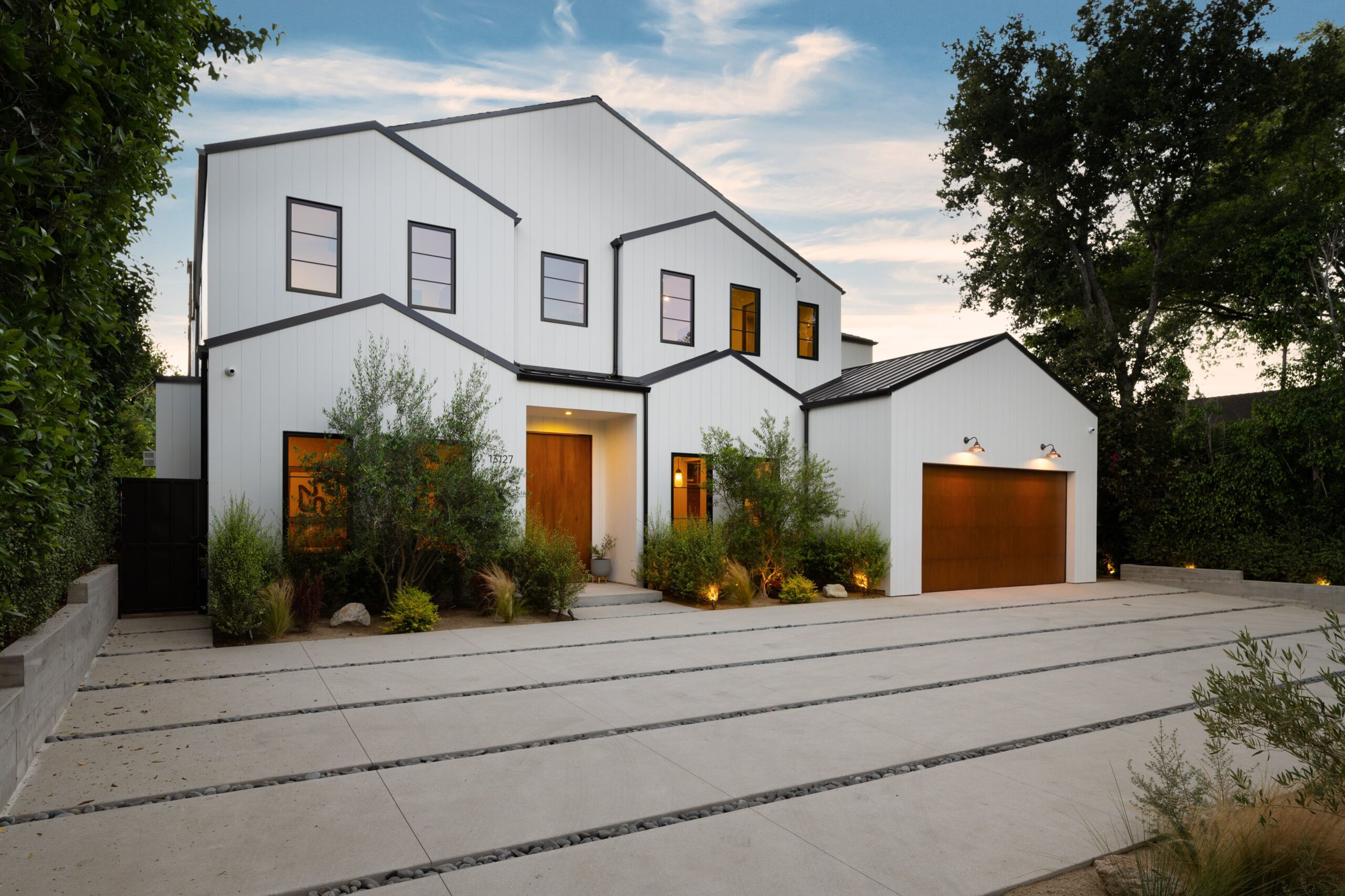 Modern white house exterior with wooden accents - Stonebrook Custom Homes | Stonebrook Custom Homes